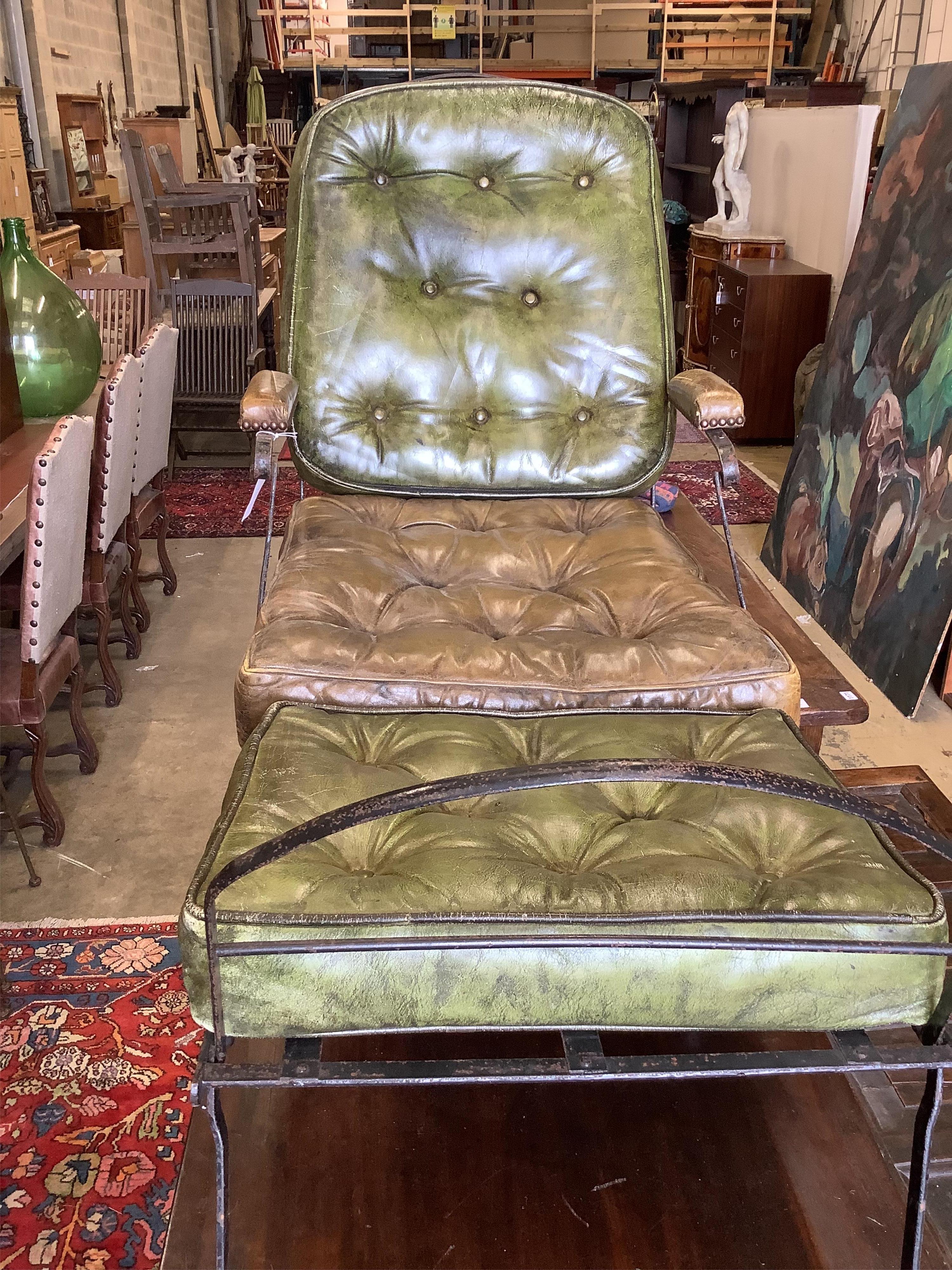 A 19th century wrought iron campaign chair with buttoned green leather seat and back